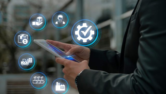 Business professional using a mobile device with digital icons representing managed IT services and business technology.