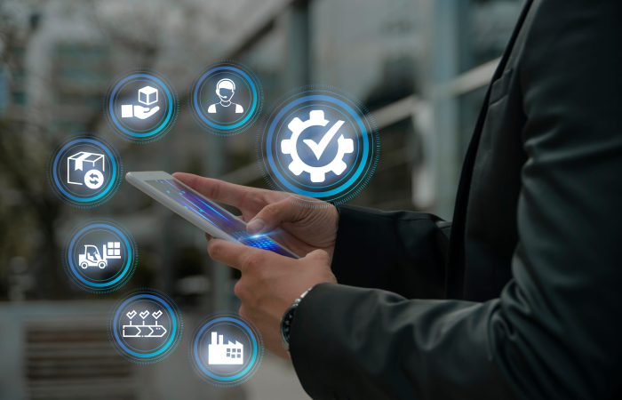 Business professional using a mobile device with digital icons representing managed IT services and business technology.