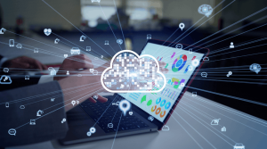 Business professional using a laptop with cloud graphics and data visualisations, representing cloud services and the difference between IaaS, PaaS and SaaS