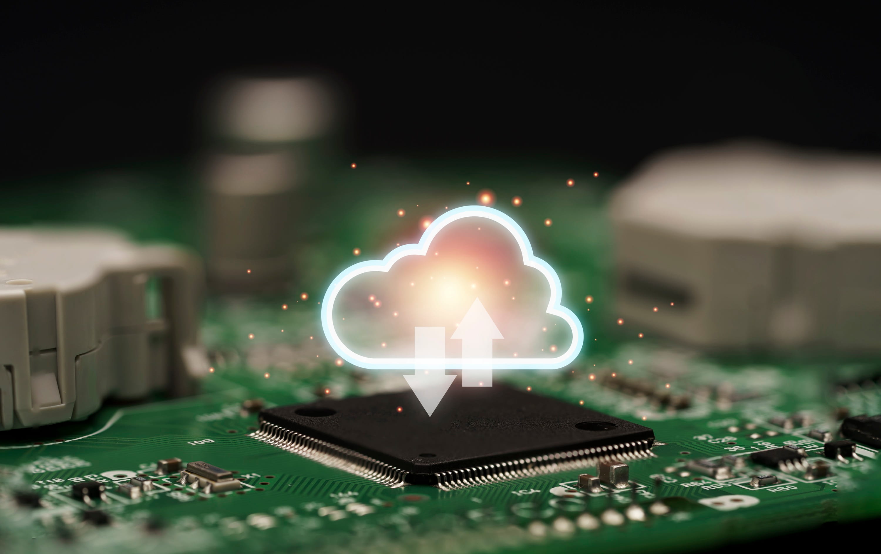 Cloud computing icon displayed above a computer chip to represent digital data transfer and cloud technology.