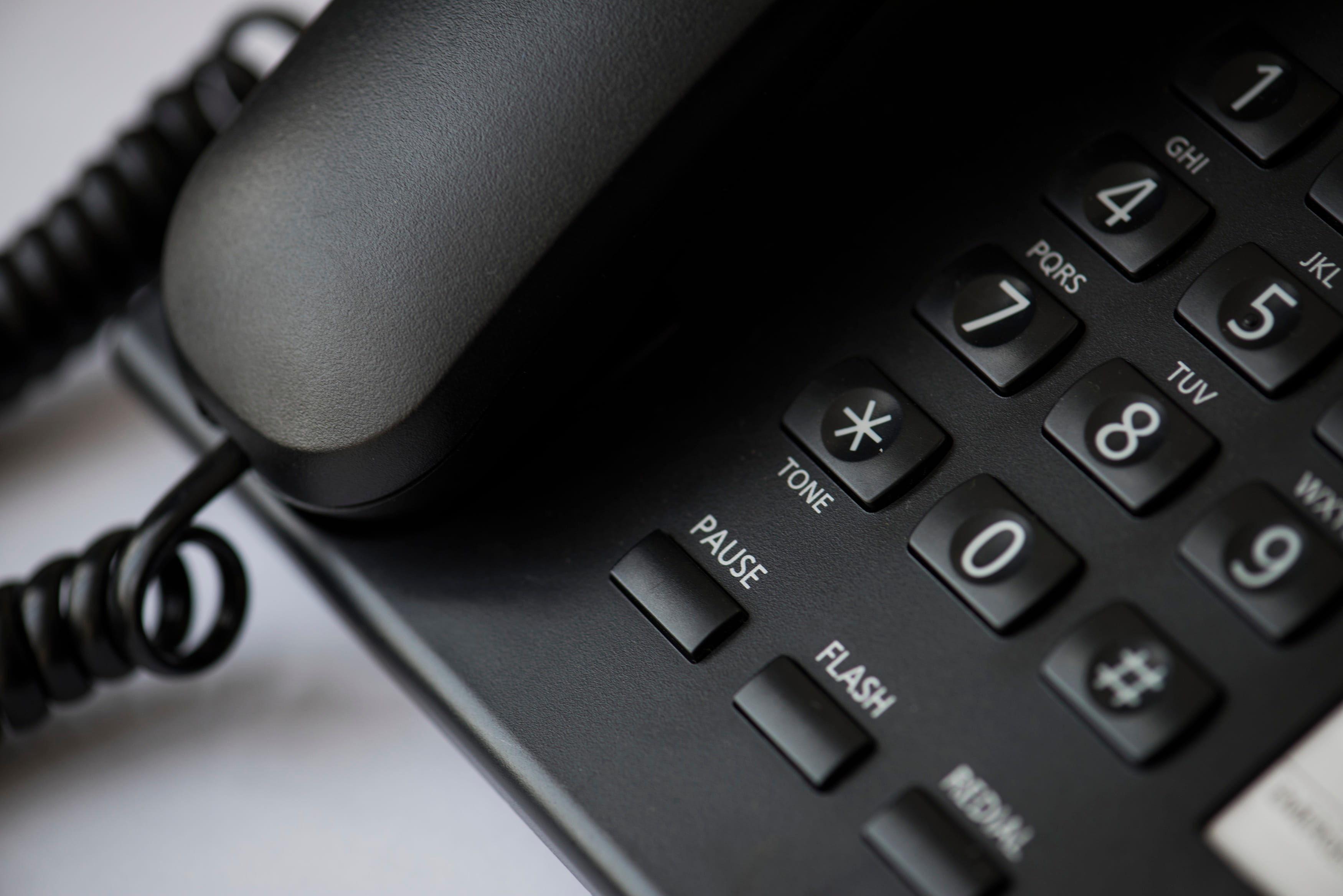 Close-up of a business desk phone used for everyday office communications.