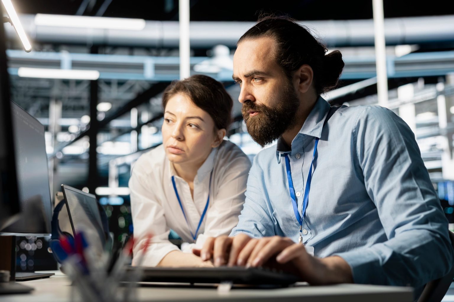 IT engineers analysing system data and running diagnostics in a data centre environment.
