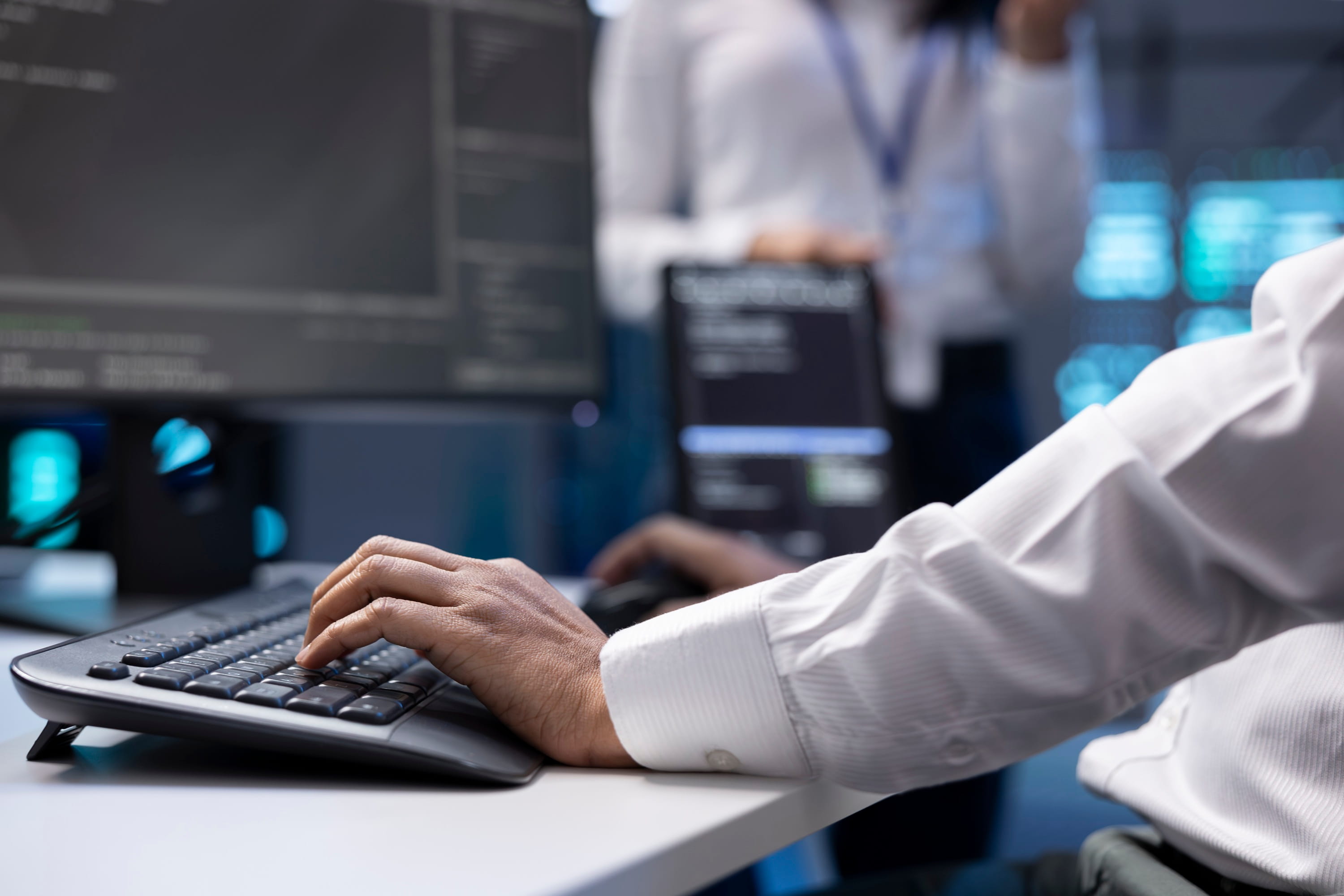 IT professional working at a computer in a server room.