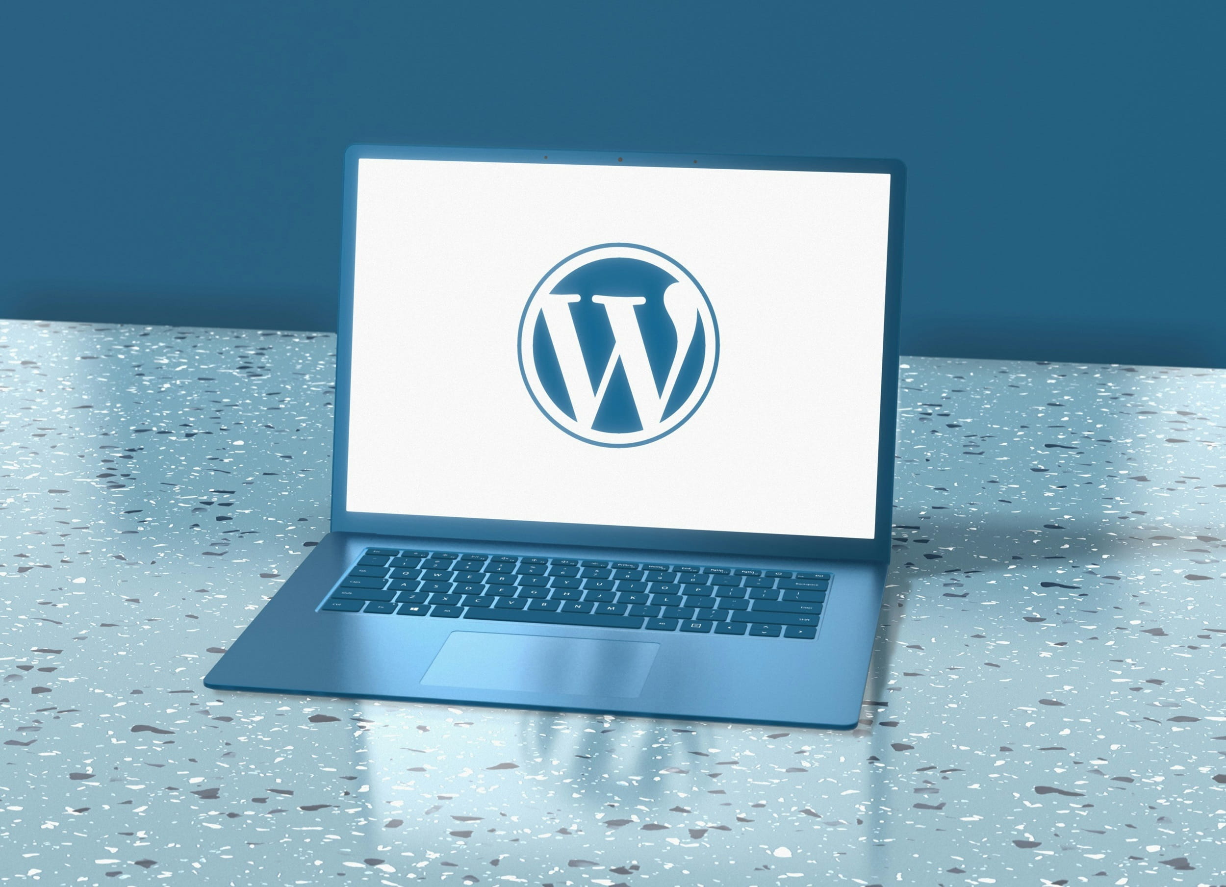 Laptop displaying the WordPress logo on screen